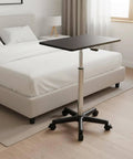 Straight Up Solid Adjustable Rolling Laptop Desk With Heavy Duty Steel Base mobile standing work table near a bed.