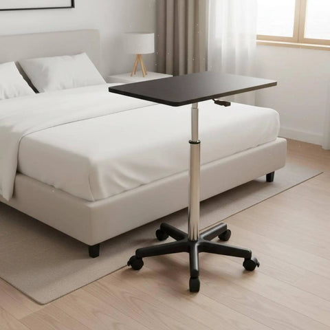 Straight Up Solid Adjustable Rolling Laptop Desk With Heavy Duty Steel Base mobile standing work table near a bed.