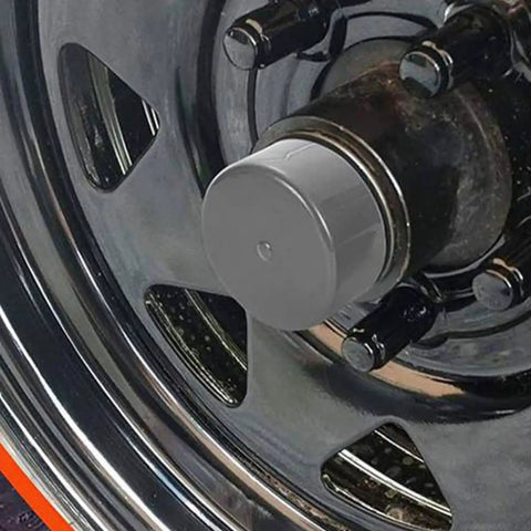 Close-up of trailer wheel with 4 Pack Trailer Hub Replacement Caps 1.98 Inch Rubber Bearing Dust Covers With Water Protection installed.