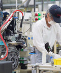 SANFU 3/8 high-flow air hose fittings on an assembly-line in a factory; steel fittings with red hoses.