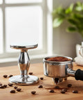 Heavyweight Dual Sided Espresso Tamper Made From Durable Aluminum With 48 Millimeter And 53 Millimeter Ends beside portafilter on table