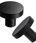 Close-up of two 30 Pack Brushed Black Round Cabinet Knobs 1-1/4 Inch For Cabinet Doors And Drawers, made from durable aluminum.