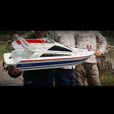 2.4G Wireless RC Speed Demon Racing Boat With Luxury Yacht Styling, Realistic Hull, held by three hobbyists outdoors