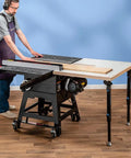 Man using Knock Down Outfeed Table Kit With Foldable Legs For Small Shops on a table saw, showcasing extension and setup.