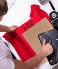 Person using 3 Pack PTFE Sheets For Heat Press 16x12 Inches Non Stick Reusable Craft Mat on a red T-shirt with heat press machine