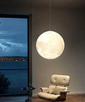 Light Up Moon 3D Printed Moon Pendant Lamp With Three Color Modes 12W E26 LED Included Moon Light For Home Office Bars Cafe 10 Inch Energy Efficient Cozy Modern Vibe illuminating a living room space.