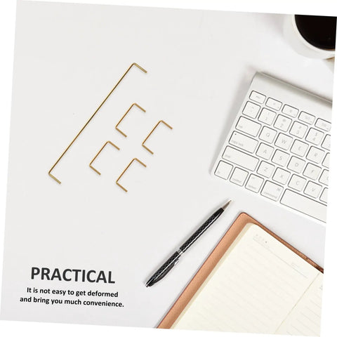 Premium Gold Plated Satellite Stabilizer Wires For Mechanical Keyboards on a desk with a notebook and pen.