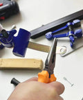 Portable Hand Vise For DIY Projects With A 2 Inch Jaw Heavy Duty Handheld Vice in use for cutting a metal piece in a workshop