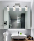 Three-Light Sleek Modern Bathroom Vanity Light With Clear Glass Shades, Wall Mounted Fixture In Black Finish above mirror