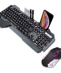 Top Tier Gaming Keyboard And Mouse Combo Featuring Colorful Breathing RGB Backlights And High Response Mouse. Ultra Lightweight Build. Precision Sensor For Pixel Perfect Tracking. Smooth Mechanical Feel Keys. Straight Fire Gear For PC Desktop Laptop. Image shows a gray keyboard with phone holder and nearby mouse.
