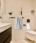 Matte Black 10 Piece Bathroom Hardware Set In SUS304 Stainless Steel with towel bar and toilet paper holder visible in modern bathroom