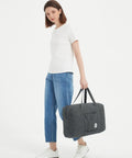 Woman holding Underseat Travel Duffel Bag 18x14x8 Inches 25L Foldable Personal Item Carry On Luggage Denim Grey For Women
