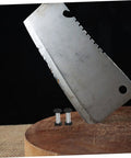 Boss Grade Stainless Steel Knife Handle Screws With Locking Spindle Pins Two Pack next to a cleaver on wooden cutting board.