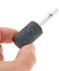 Hand holding a 20mm aluminum oxide cylindrical grinding stone with 1/4 inch hex shank from a Ten Piece 20mm Aluminum Oxide Cylindrical Mounted Grinding Stones Set With One Quarter Inch Hex Shank For Electric Rotary Tools Drill Grinder Pro Grade Durable For Metal Shaping Deburring And Precision Work