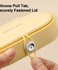 Close-up of yellow round case and secure silicone pull tab from Grab And Go Travel Sewing Kit With Round Case Emergency Repair Gear