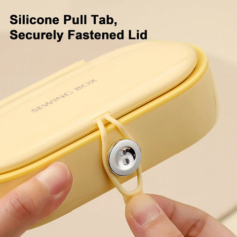 Close-up of yellow round case and secure silicone pull tab from Grab And Go Travel Sewing Kit With Round Case Emergency Repair Gear