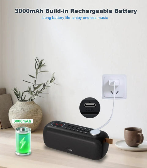 Bluetooth Speaker With FM Radio And 5 In 1 Music Player charging on table, showing 3000mAh battery indicator, USB port detail.