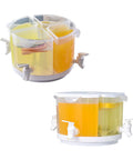 Five Point Five Liter Rotating Beverage Dispenser With Four Separate Compartments And Dripless Spigot featuring yellow liquids in a sleek white finish.