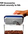 Hand securing lid on Keep It Fresh With Airtight Pop Containers, 4.4 Qt Capacity, Stackable Dry Food Storage That Fits Your Pantry.