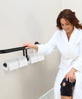 No Sweat Matte Black Grab Bar With Double Toilet Paper Roll Holder Combo installed in bathroom with user in robe.