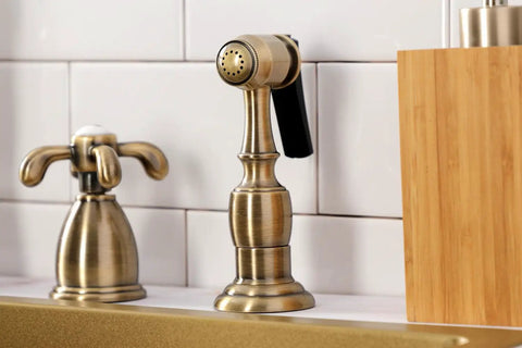 Close-up of French Country Widespread Kitchen Faucet With Brass Sprayer in Oil Rubbed Bronze, showing detailed brass construction.