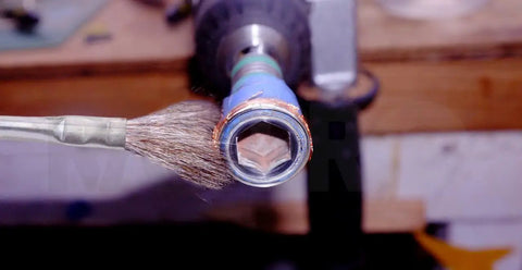 Horsehair Flux Brushes 36 Pack With Five And A Quarter Inch Handles And Three Eighths Inch Bristles in use on metal tool