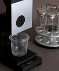 Commercial Coffee Bean Batch Dispenser And Boss Level Weighing Scale For Specialty Cafes Heavy Duty Aluminum Body displaying a transparent cup on a scale.