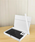 Robust White PVC And Acrylic Model Tool Storage Rack Featuring Multi Compartment Design For Diy Hobbyists open on a desk with a black pegboard surface.