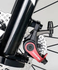 Beast Mode Mountain Bike Front Disc Brake Kit With Twin Piston Mechanical Caliper And Machined Aluminum Body Built Tough For Electric Bikes detail of red and silver caliper on bike fork