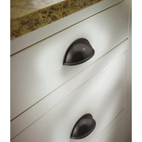 Top Shelf Rustic Bin Cup Pulls With Slick Oil Rubbed Bronze Finish on white kitchen drawers, showing stylish design and smooth functionality.