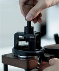 Premium Game Changer 58Mm Espresso Coffee Distributor With Magnetic Base And Precision Rotary Needles being operated to level coffee grounds.