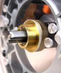 Close-up of 9-piece Brass Router Bushing Set installed on router base with 1-3/16 inch plate opening for precise edge routing.