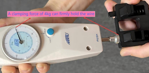 Close-up of hands operating clamping tool with dial measuring 4kg force, holding wire securely in place.