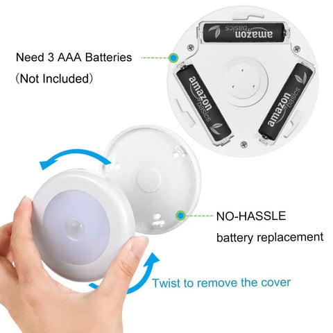 Hand demonstrating battery replacement for Upgraded 3.15 Inch Motion Sensor LED Light Stick On Battery Powered Night Lights White Pack Of 6