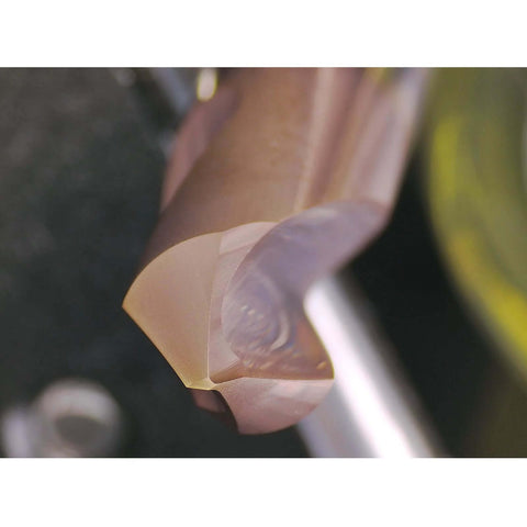 Close-up of WEXWE chamfer end mill tip with bronze coating; 90° two-flute for alloy and hardened steel.