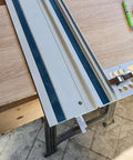 Pro Grade Right Angle Saw Guide Rail Stop For 260mm Track Saws attached to a wooden workbench, showing CNC machined aluminum square.