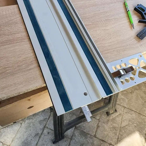 Pro Grade Right Angle Saw Guide Rail Stop For 260mm Track Saws attached to a wooden workbench, showing CNC machined aluminum square.