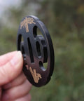 Samurai Sword Koshirae Tsuba Iron Carved 001-026 TDH 026 hand guard held showing side detail with carved design.