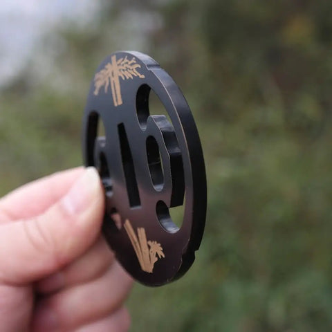 Samurai Sword Koshirae Tsuba Iron Carved 001-026 TDH 026 hand guard held showing side detail with carved design.