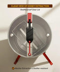 Top view of He3Man 3 Frame Beekeeping Drum Honey Extractor with stand, showing the shatterproof clear lid and hand crank mechanism.