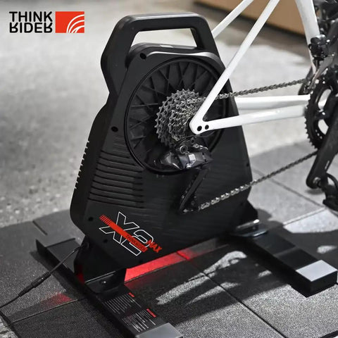 Quiet Portable Smart Bike Trainer For Indoor Rides With 18 Percent Slope Simulation, ANT Plus And BLE, attached to a bike.