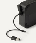 Back view of Compact Bluetooth Speaker With IPX5 Waterproof Rating, 6 Hour Playtime, USB C Charging cable shown connected
