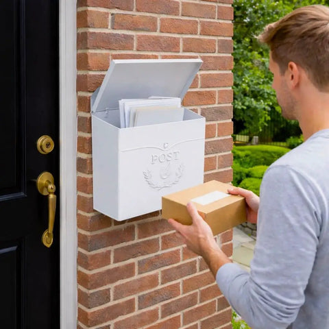 Man placing package in Outdoor Wall Mount Mailbox 11.5 x 5 x 13 Inches White Waterproof Heavy Duty Metal Mailbox for Outside, mounted on brick wall.
