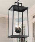 Large Twenty Five Inch Outdoor Pendant Light With Clear Glass And Sturdy Metal Build hangs in a porch with a cozy glow.