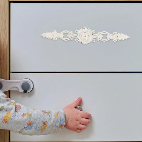 Child opening drawer with Vintage European Zinc Alloy Cabinet Handle With Floral Decorative Door Pulls For Dresser And Drawer, Chrome Ivory Finish.