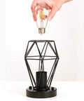 Hand installing bulb into 2-Pack Semi Flush Mount Ceiling Light Set In Industrial Black, Hollow Metal Cage Pendant Fixtures