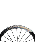 Close-up of the Carbon Disc Wheelset Tubeless Ratchet Bike Wheel 700C 50mm Black, showing spoke detail and rim design.