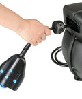 Hand pulling cord from Heavy Duty 50 Foot Cord Reel Extension With Slow Retraction Technology, enclosed spring-driven case visible