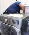 Man installing 137544800 Water Inlet Valve for Electrolux Dryers Replaces AP5736218 on a stainless steel dryer