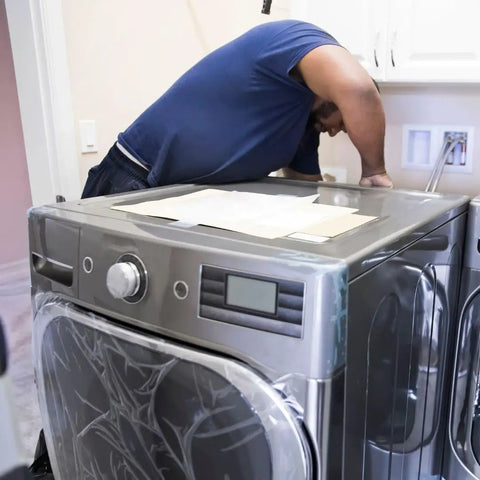Man installing 137544800 Water Inlet Valve for Electrolux Dryers Replaces AP5736218 on a stainless steel dryer